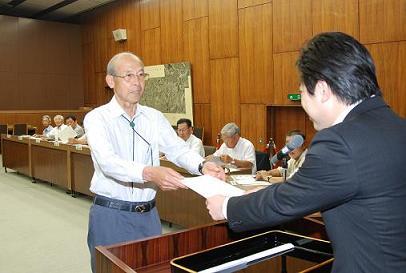 区長会連合会長の舩橋茂行委員へ市長が委嘱状を交付している写真